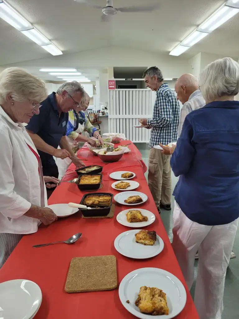 Lining up for a lasagna meal.
