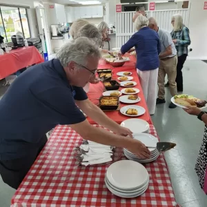 Handing out plates of lasagna at the club.